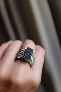 Elastic steel ring with silver decoration and black zirconia