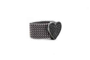 Elastic steel ring with a silver decoration and zirconia.